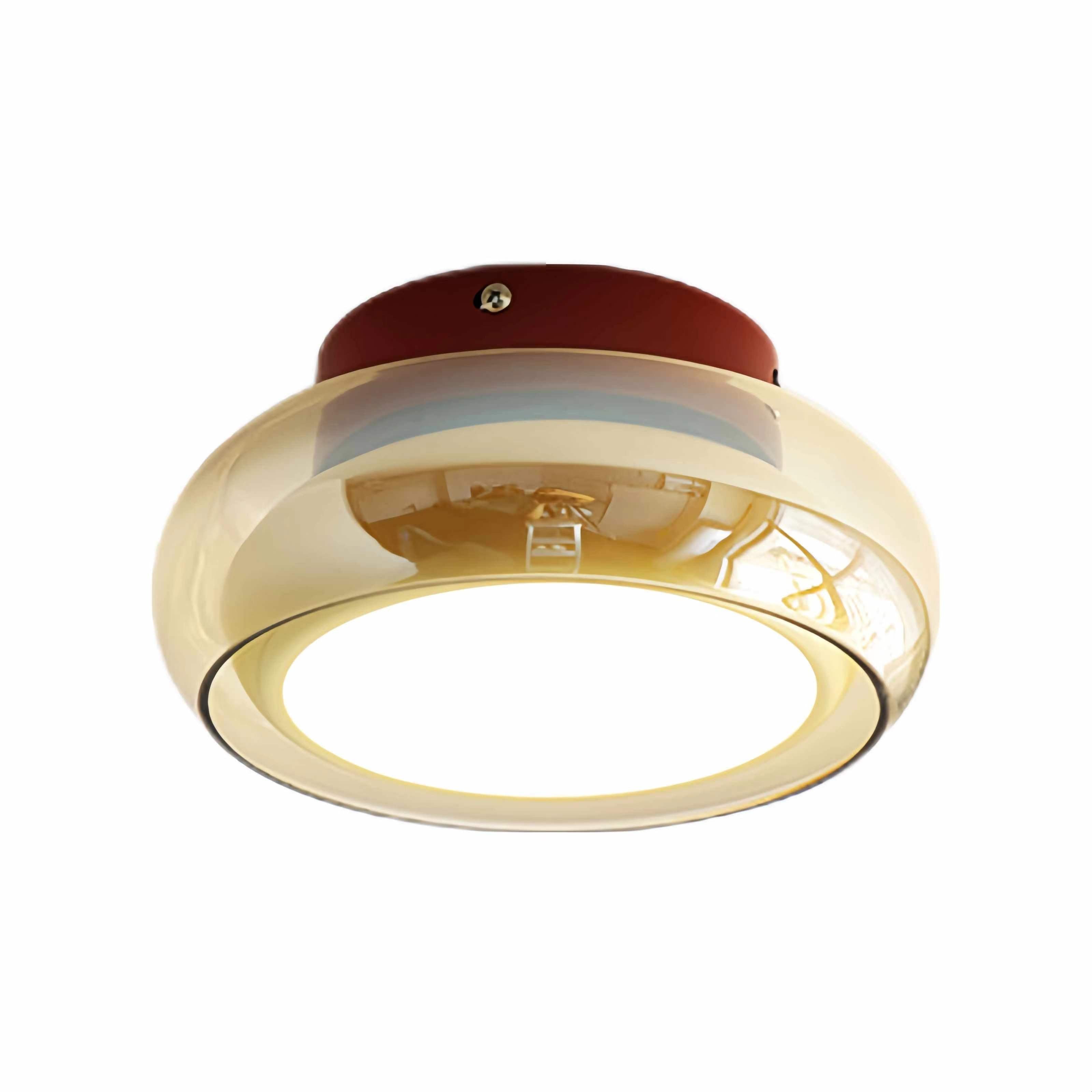 Amber glass ceiling light with a round illuminated center on a plain background.