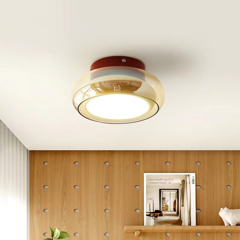 Amber glass ceiling light mounted above a wood-paneled room.