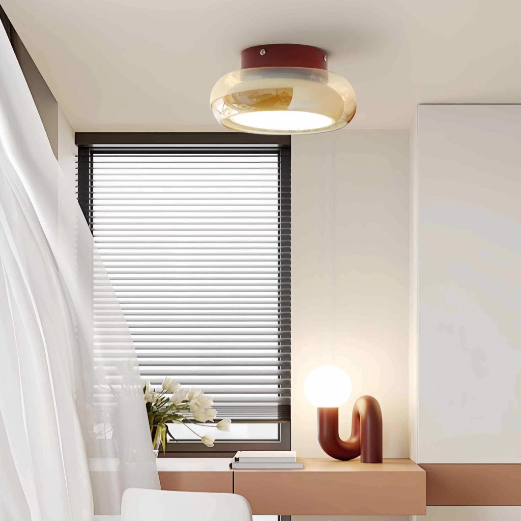Amber glass ceiling light mounted near a bedroom window.