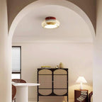 Amber glass ceiling light beneath an arched ceiling in a sitting room.