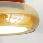 Amber glass ceiling light close-up showing the tinted outer shade.