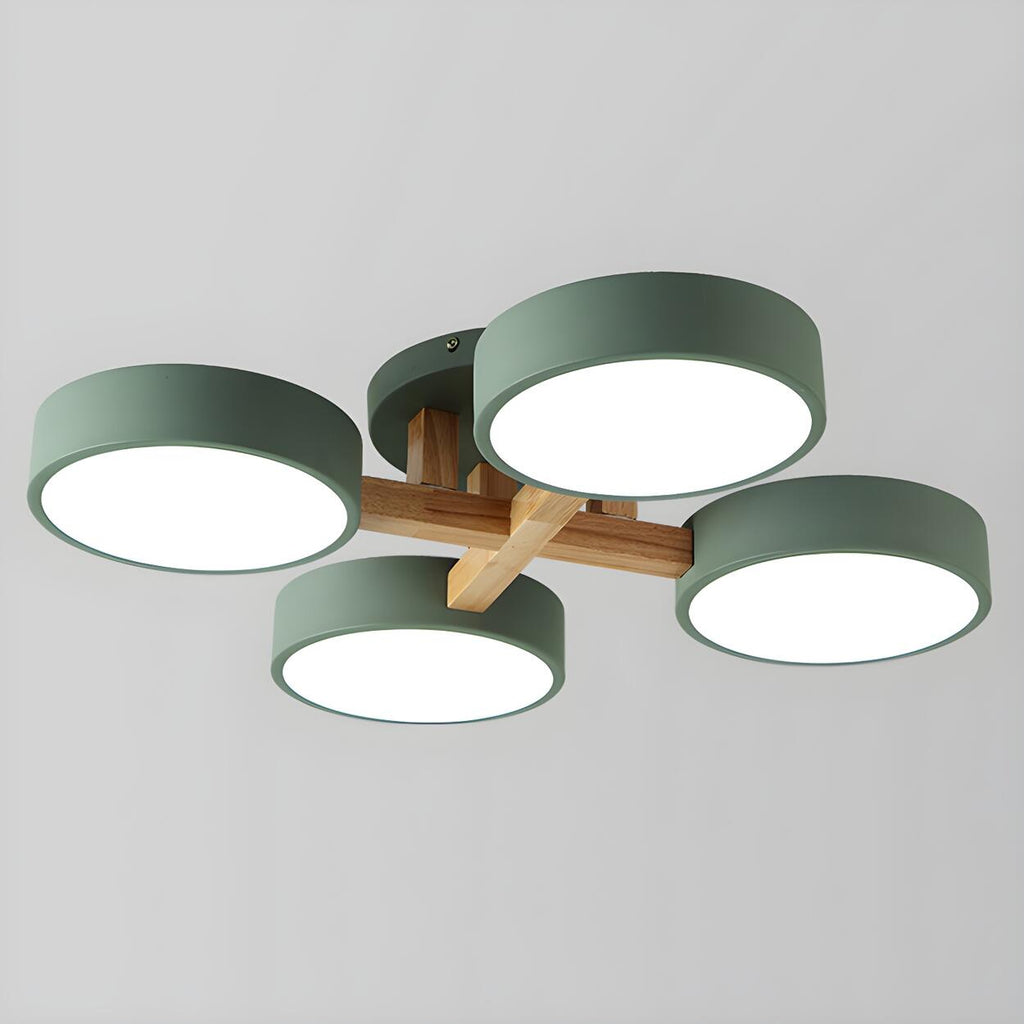 Green ceiling light with four round shades and crossed wood details.