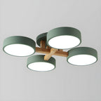 Green ceiling light with four round shades and crossed wood details.