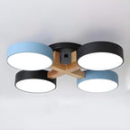 Blue and black ceiling light with four round shades and wood details.