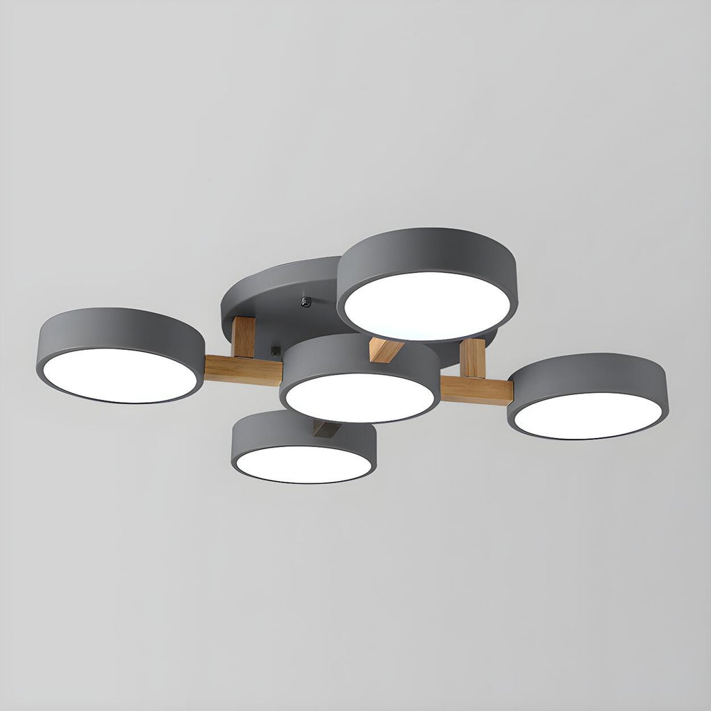 Gray ceiling light with five round shades and wood details.