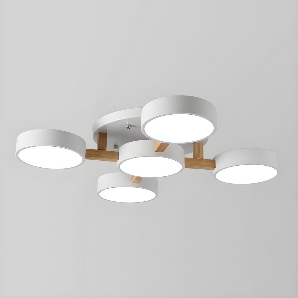 White ceiling light with five round shades and wood details.
