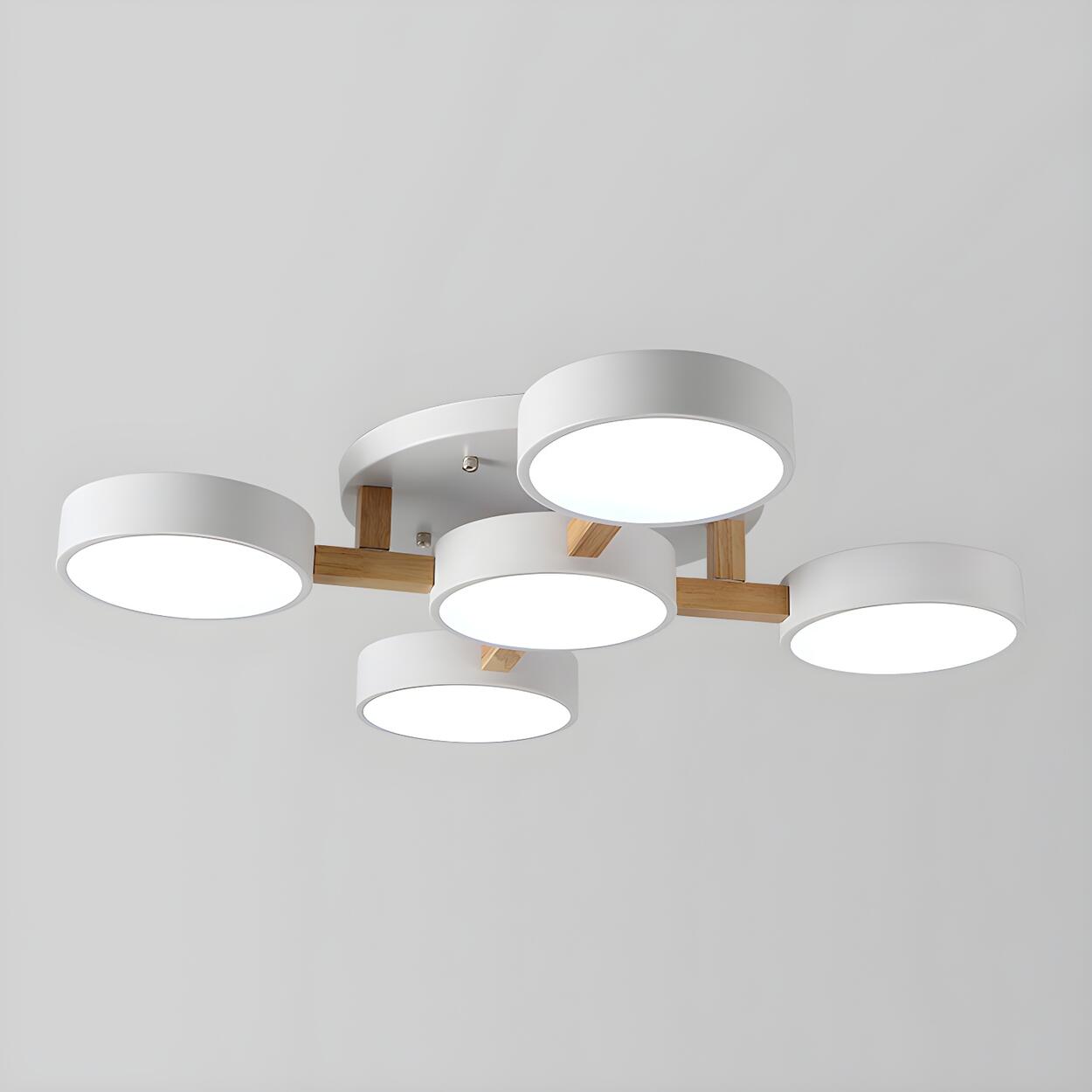 White ceiling light with five round shades and wood details.