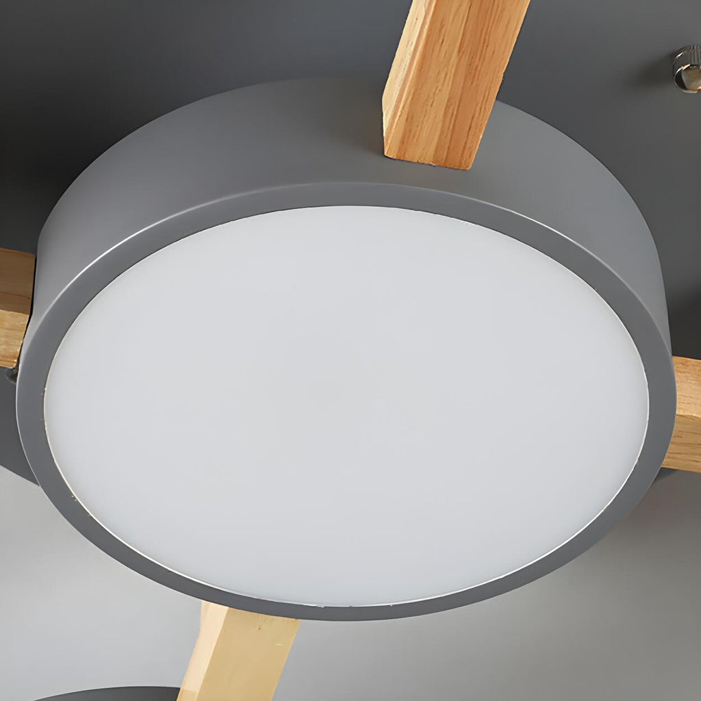 Close detail of a gray round shade and wood support on the ceiling light.