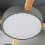 Close detail of a gray round shade and wood support on the ceiling light.