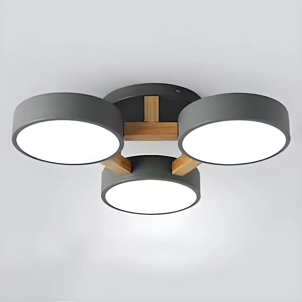 Gray ceiling light with three round shades and a wood support detail.