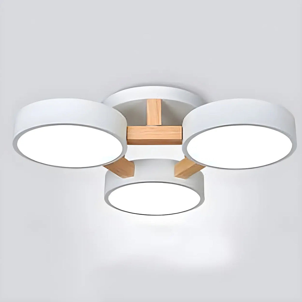 White ceiling light with three round shades and wood details.