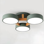 Green ceiling light with three round shades and wood details.