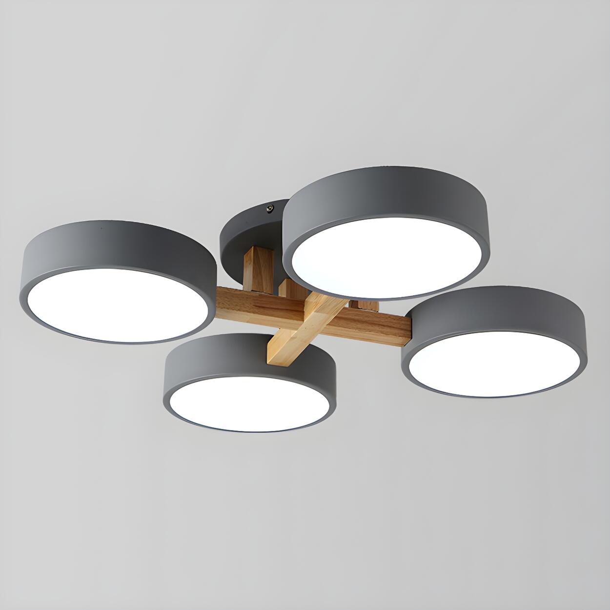 Gray ceiling light with four round shades and crossed wood details.