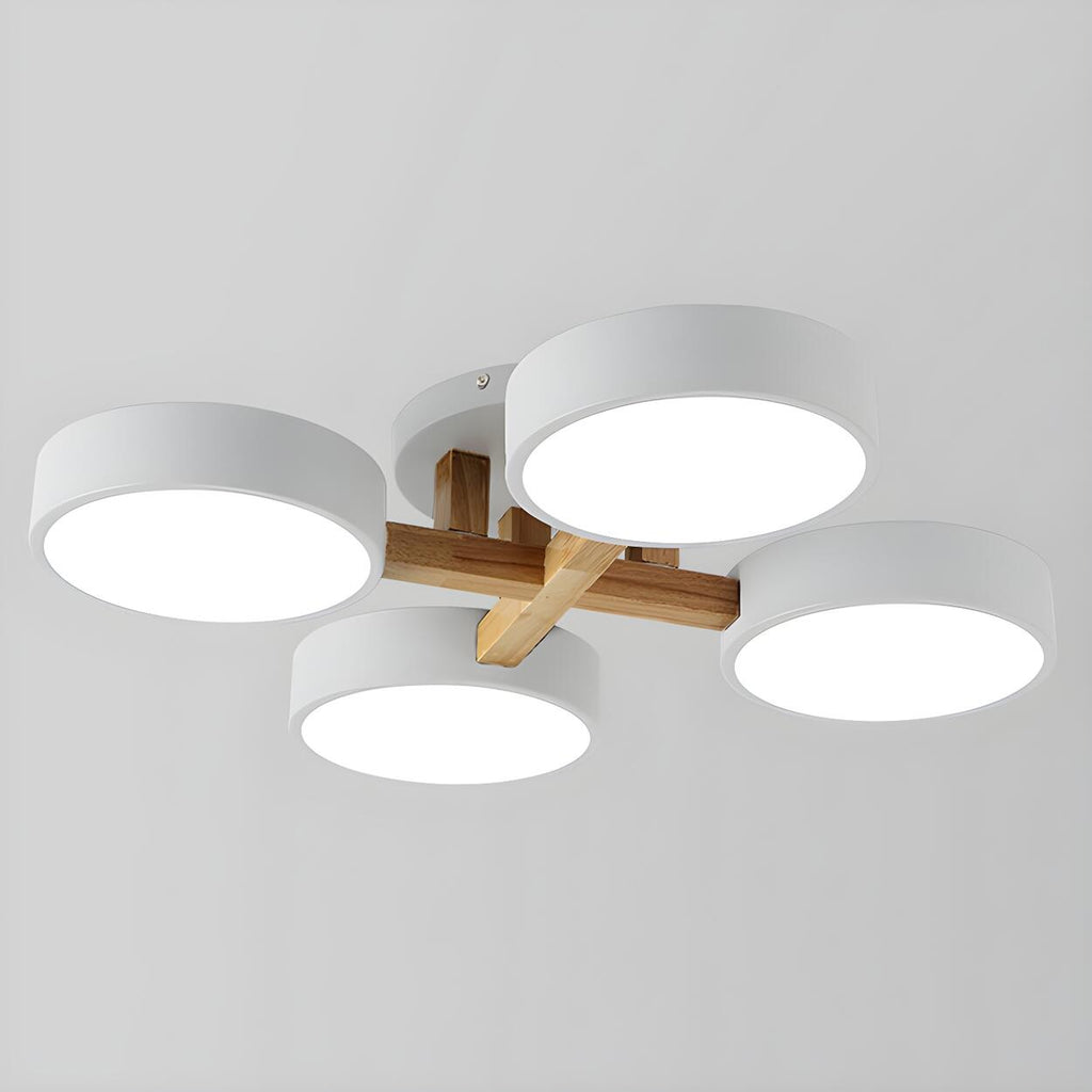 White ceiling light with four round shades and crossed wood details.