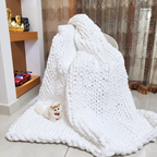 White chunky chenille throw blanket draped over a chair