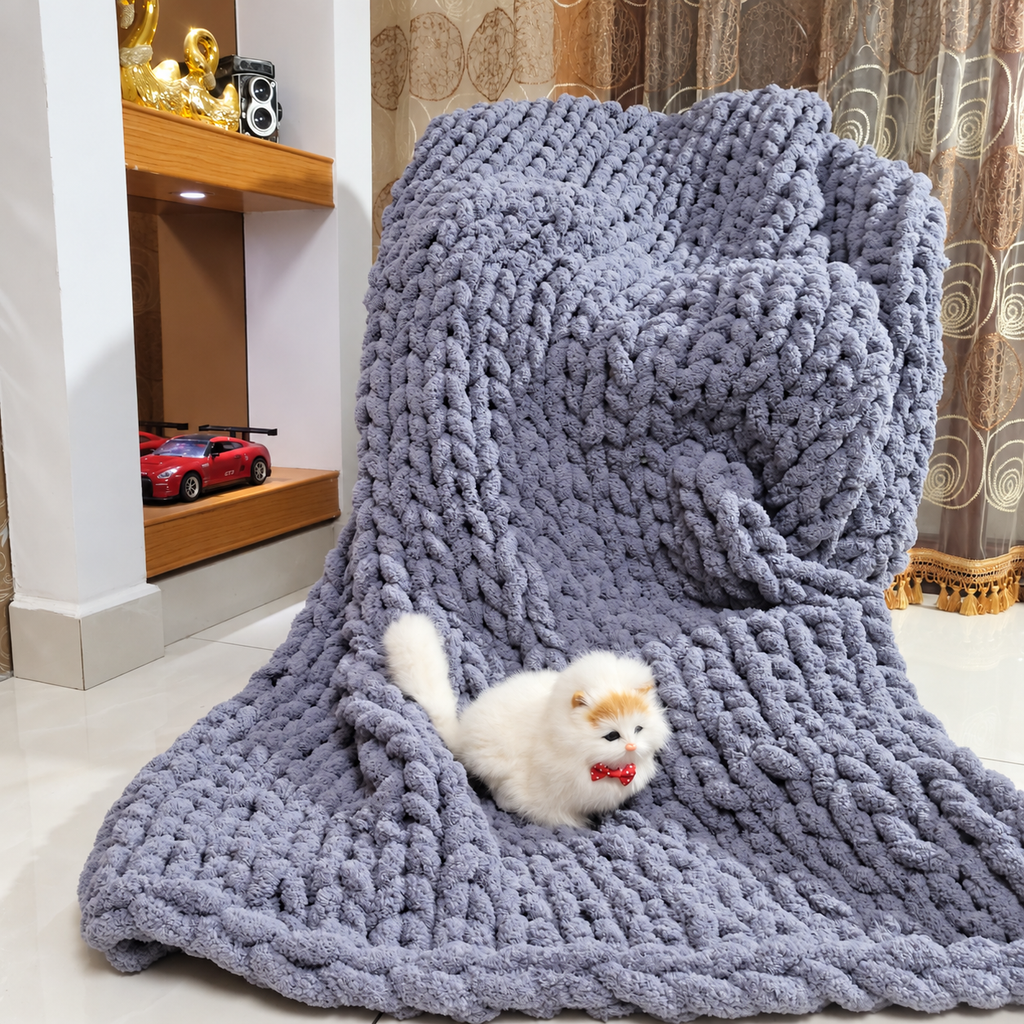 Light gray chunky chenille throw blanket draped over a chair