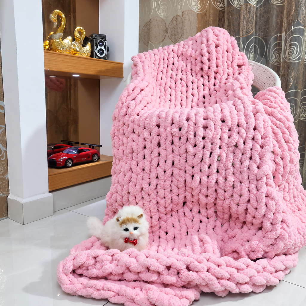 Pink chunky chenille throw blanket draped over a chair