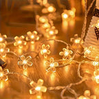 Cherry blossom string lights glowing in a tabletop arrangement.