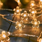 Cherry blossom string lights arranged across wooden boards.