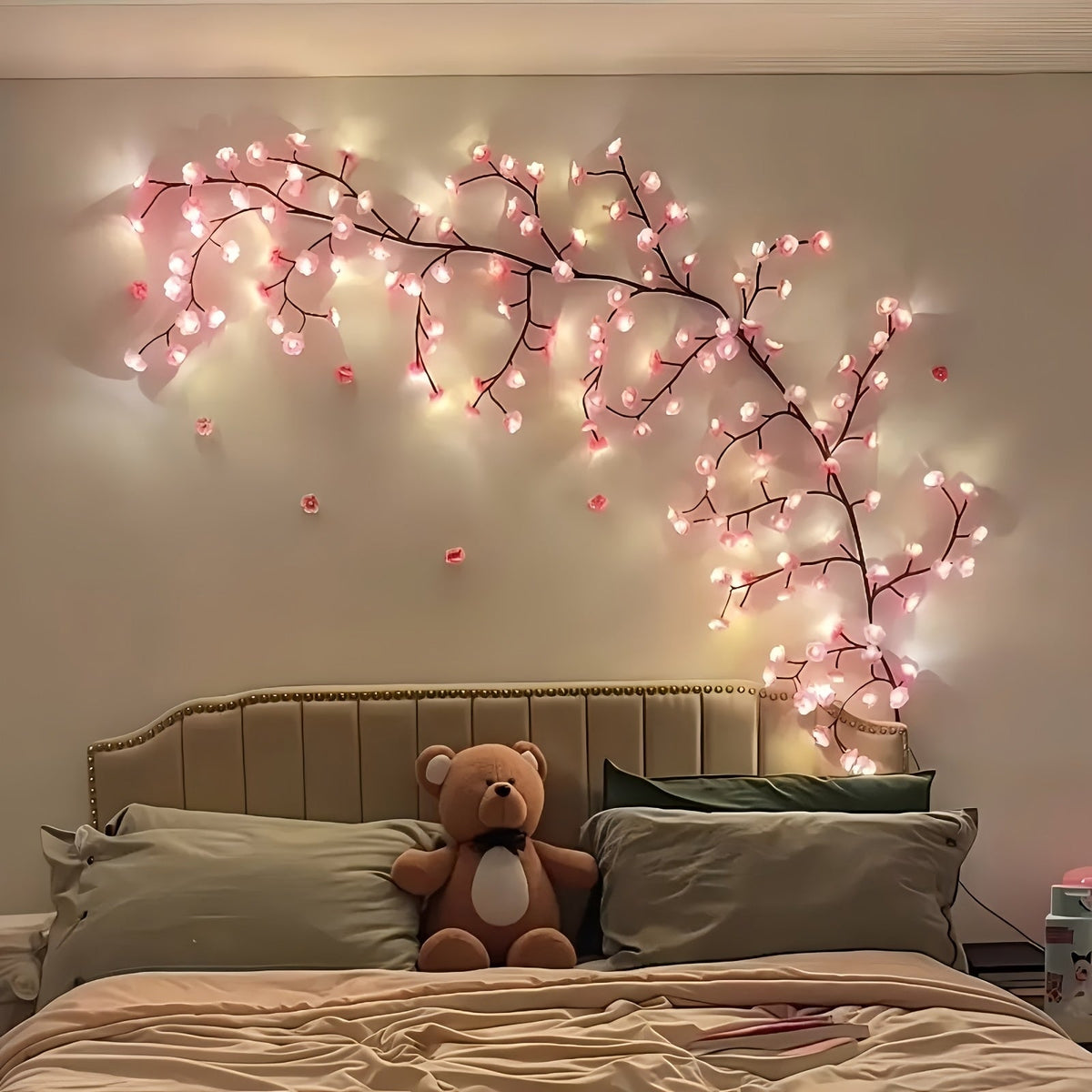 Cherry blossom vine lights above a bedroom headboard