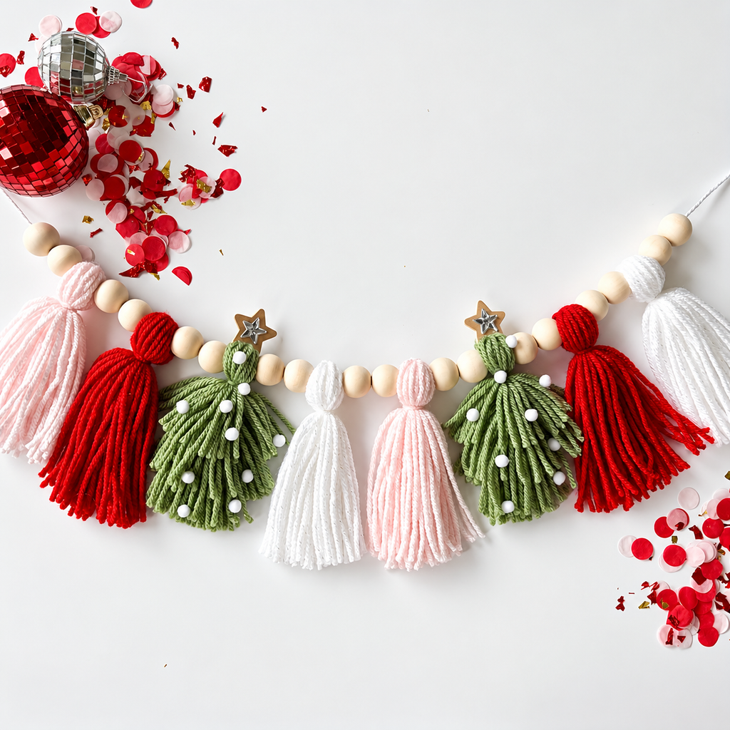 Christmas tassel garland with pink, red, green and white tassels, wooden beads and star accents.