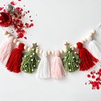 Christmas tassel garland with pink, red, green and white tassels, wooden beads and star accents.