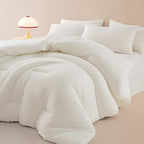 White cloud soft quilted comforter on a styled bed