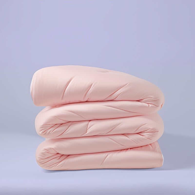 Pink comforter neatly folded