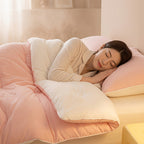 Pink comforter with a smooth white reverse on a bed