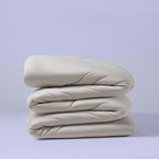 Gray comforter folded to show quilted construction