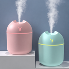 Pink and blue humidifiers releasing mist on grey stepped stands