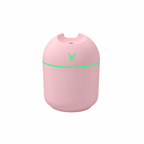 Pink rounded humidifier with a green light ring on a white background