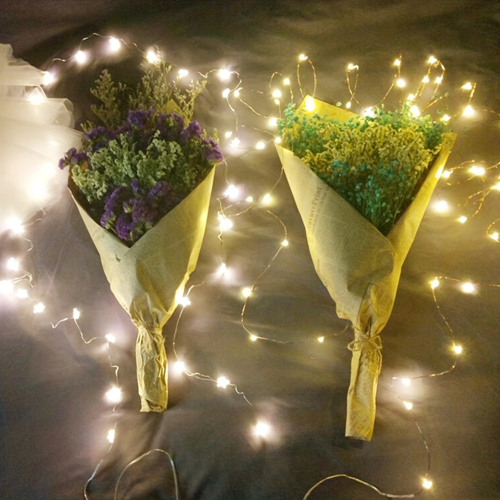Copper fairy lights decorate two flower bouquets.