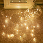 Copper fairy lights spill from a clear jar onto a softly lit surface.
