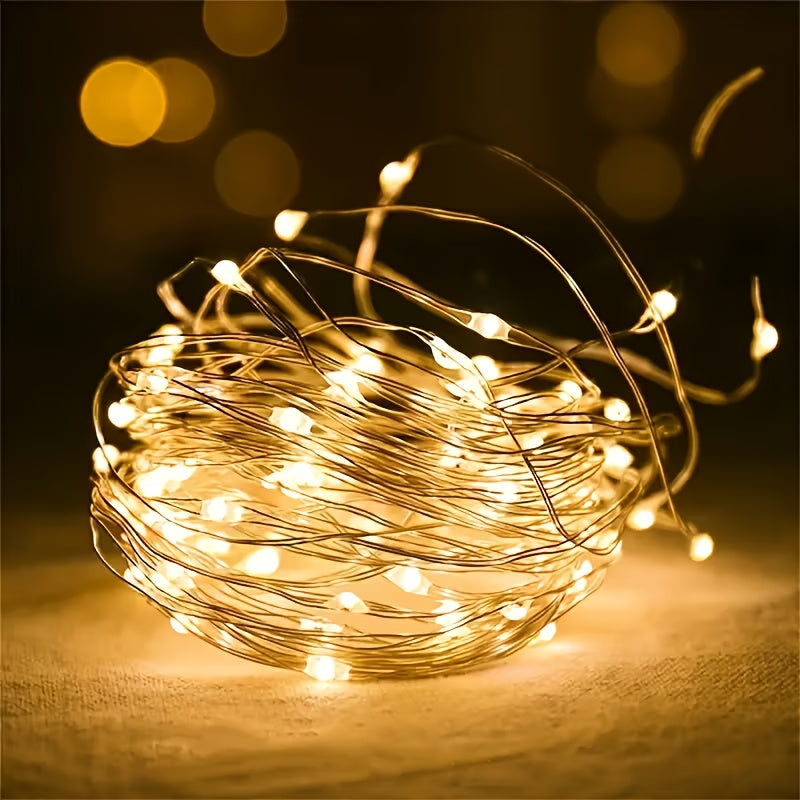 Warm white copper wire fairy lights coiled inside a clear glass bowl
