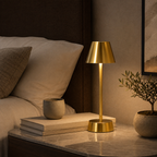 Brass cordless table lamp on a stone nightstand in a walnut bedroom