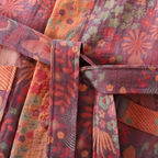 Close view of pink vintage floral double gauze cotton robe fabric and stitching.