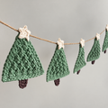 Crochet style Christmas tree garland with green trees, white star toppers and brown trunks.