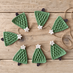Crochet style Christmas tree garland spread across a wood surface.