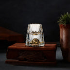 Crystal drinking glass with a pointed gold decorative base