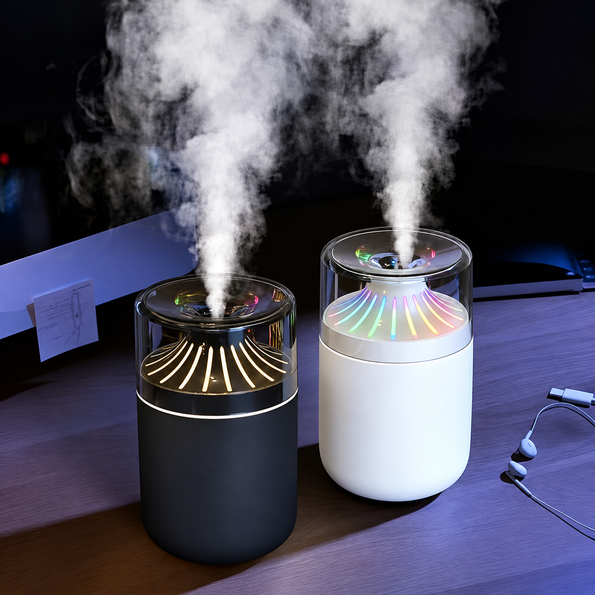 Black and white cup humidifiers releasing mist on a dark desk