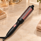 Heated round styling brush with a rose pink barrel and black handle