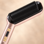 Champagne electric straightening brush showing the comb teeth and handle controls