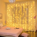 Curtain fairy lights glowing across a bedroom window.