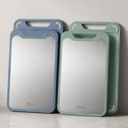 Double sided cutting board with stainless steel and green PP surfaces.