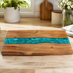 Acacia resin river cutting board lying on a wood kitchen surface.