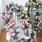 Pink and gold decorated Christmas garlands with snow flocked greenery