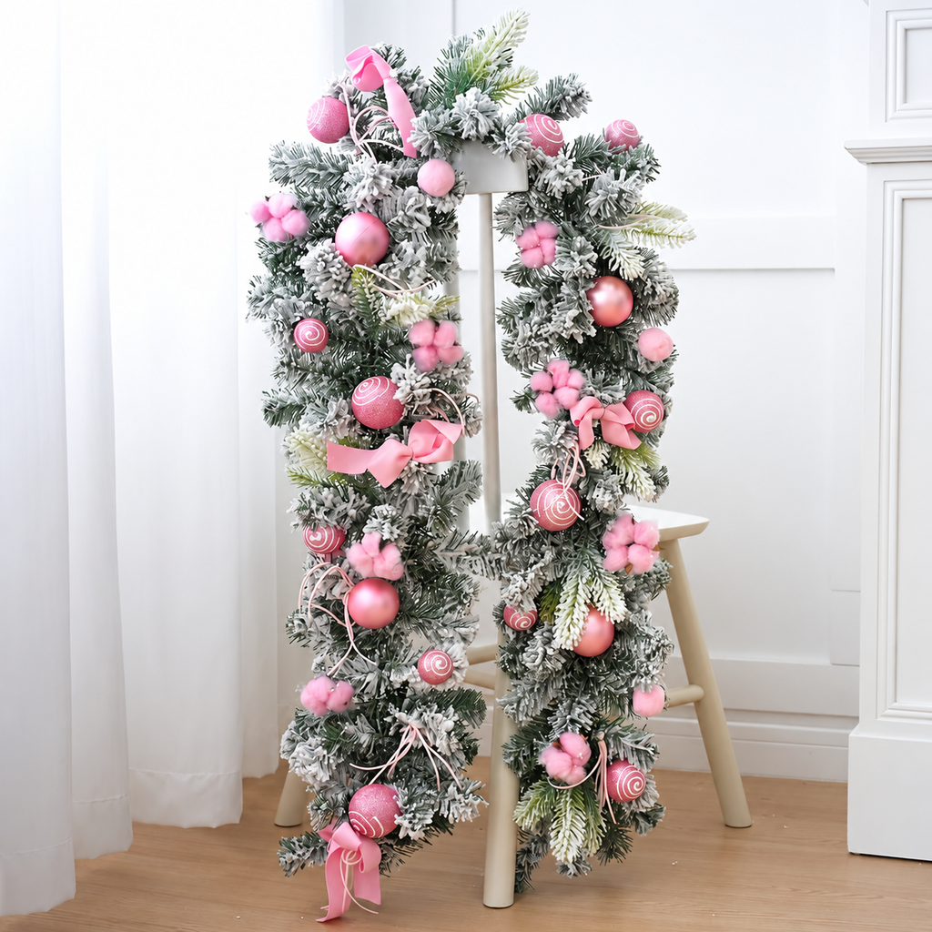 Pink decorated Christmas garland with baubles and bows displayed on a stand