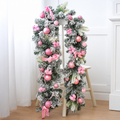 Pink decorated Christmas garland with baubles and bows displayed on a stand