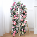 Pink decorated Christmas garland with baubles and bows displayed on a stand